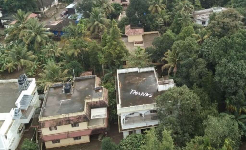 Image result for kerala flood 'Thanks' in large letter on their rooftop.