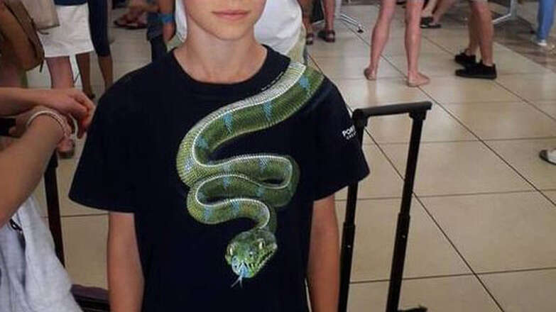 snake shirt, boy removes shirt before flight