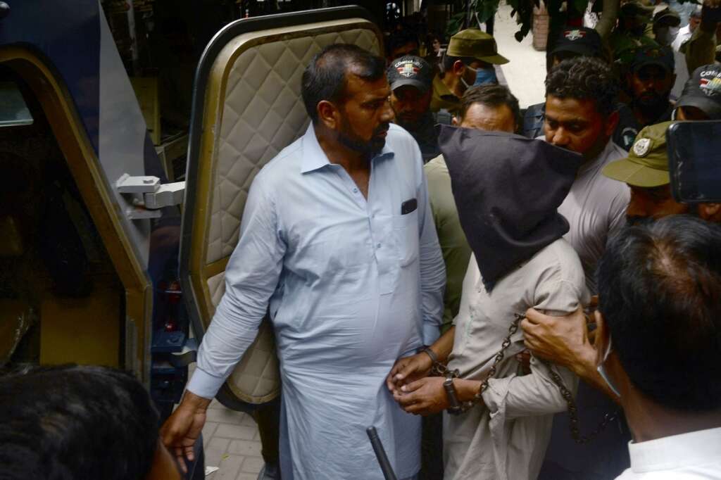 Policemen Escort Pakistani National Ahmed Quddus